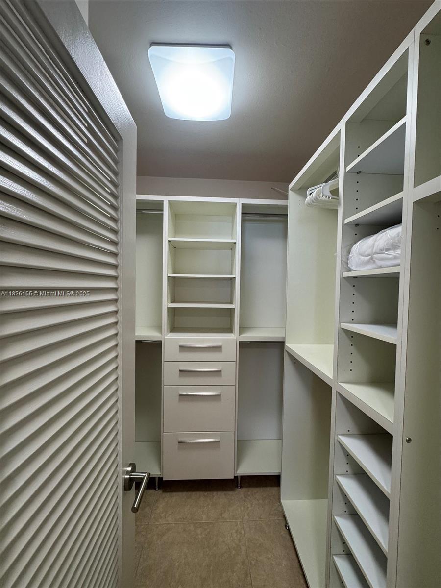 5151 Collins Avenue, Unit 535 Miami Beach, FL 33140 - Photo 14 of 34 a view of walk in closet with empty racks