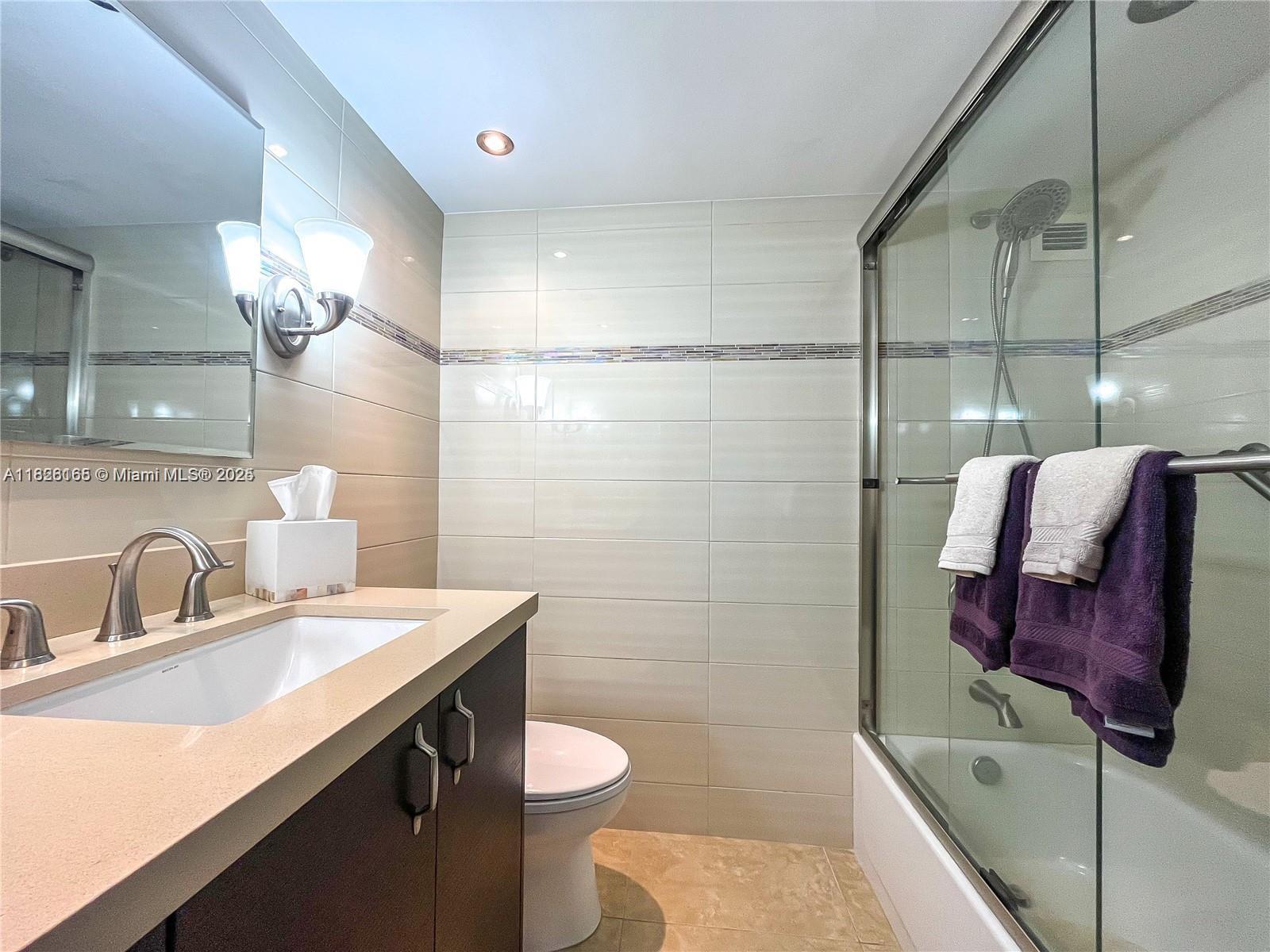 5151 Collins Avenue, Unit 535 Miami Beach, FL 33140 - Photo 20 of 34 a bathroom with a sink toilet and shower