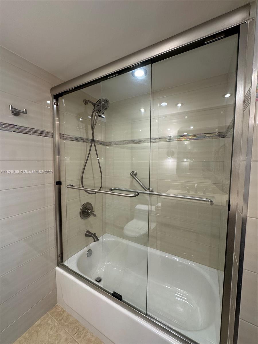 5151 Collins Avenue, Unit 535 Miami Beach, FL 33140 - Photo 22 of 34 a bathroom with a bathtub and a shower