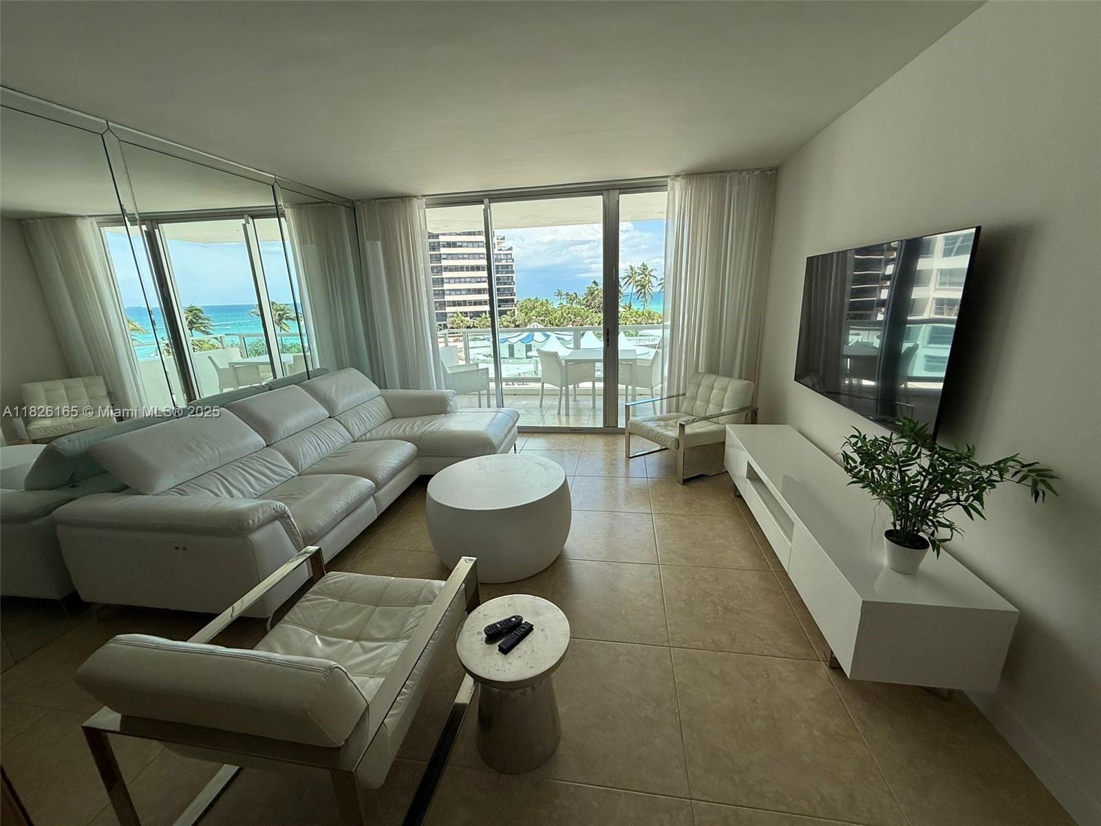 5151 Collins Avenue, Unit 535 Miami Beach, FL 33140 - Photo 7 of 34 a living room with furniture and a large window