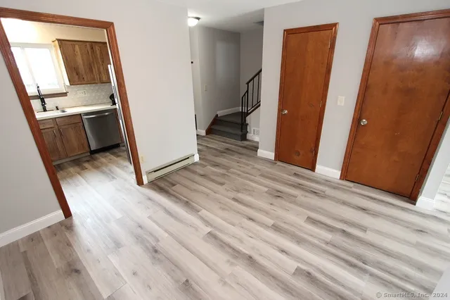 a view of a kitchen from a hallway