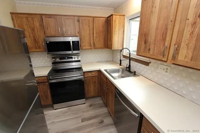 a kitchen with a sink appliances and cabinets