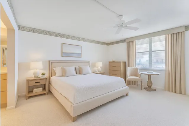 a bedroom with a large bed and a table lamp