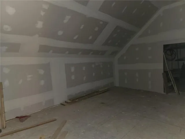 a view of a small house with yard and tree s