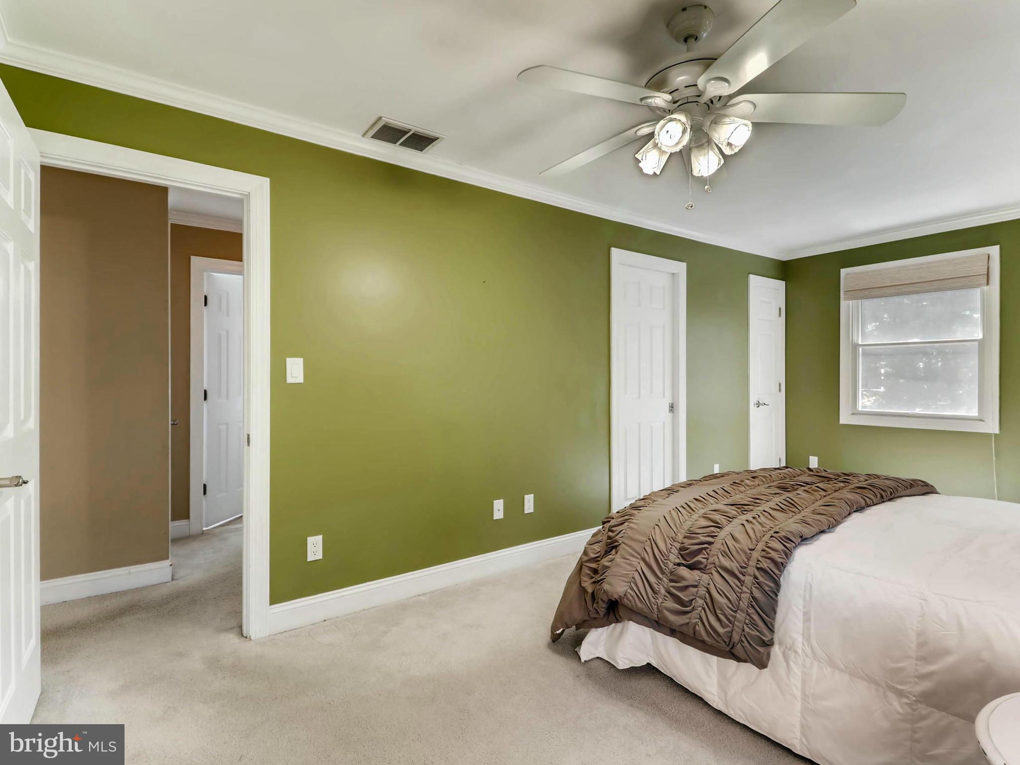 173 Copper Road Severna Park, MD 21146 - Photo 12 of 29 a spacious bedroom with a bed and a chandelier