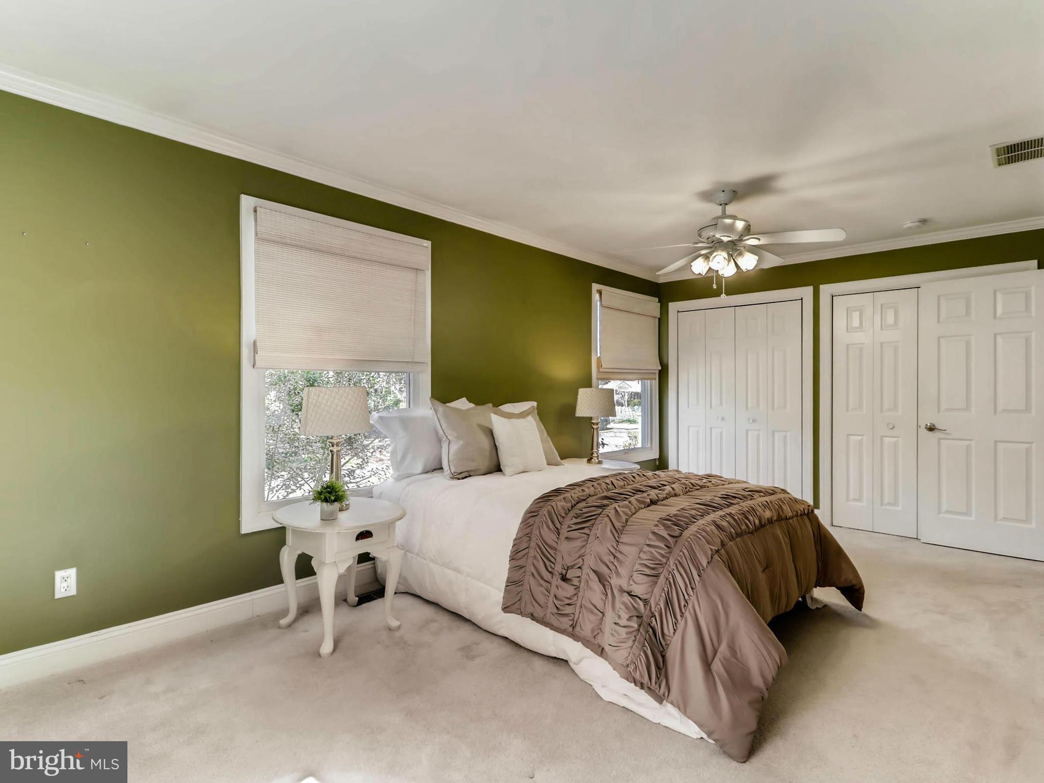173 Copper Road Severna Park, MD 21146 - Photo 13 of 29 a spacious bedroom with a bed and a chandelier