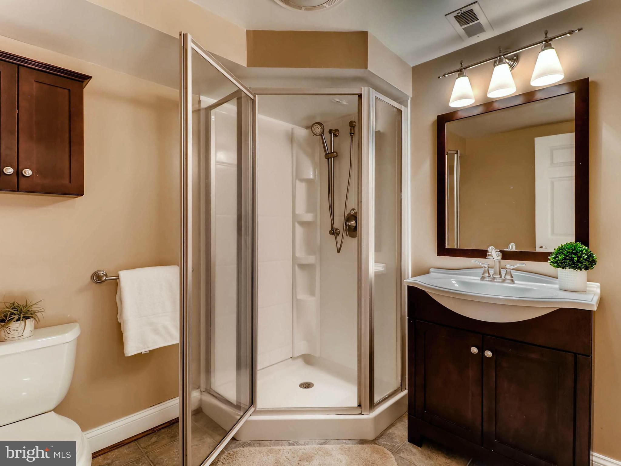 173 Copper Road Severna Park, MD 21146 - Photo 22 of 29 a bathroom with a double vanity sink mirror and shower