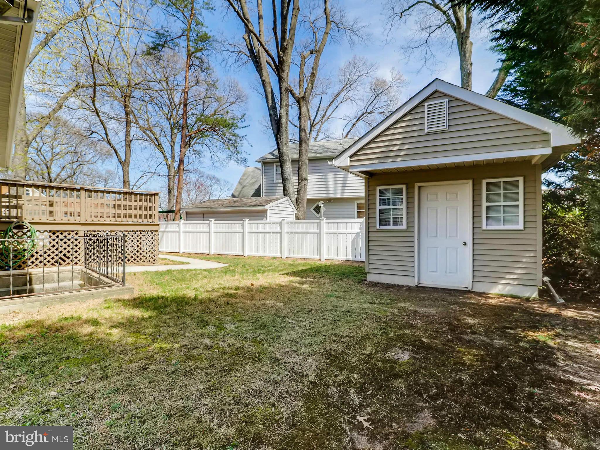 173 Copper Road Severna Park, MD 21146 - Photo 24 of 29 a view of a house with a large tree and a yard