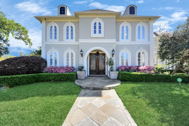 a view of a brick house with a yard