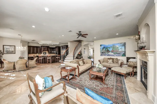 a bathroom with a granite countertop sink a toilet and shower