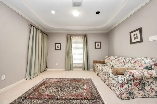 a spacious bedroom with a bed and a chandelier