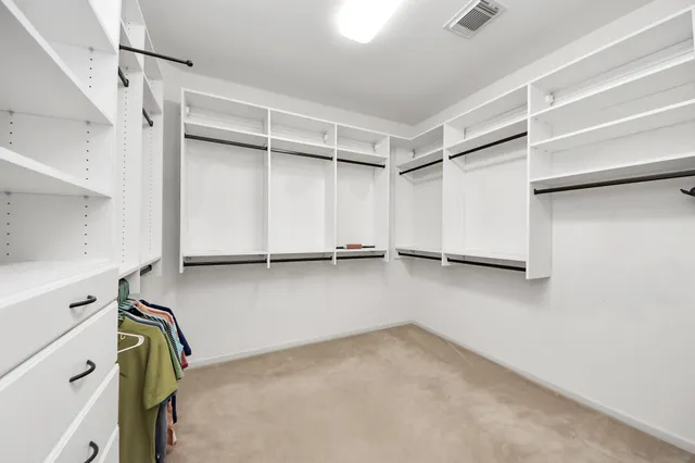 a view of a patio with table and chairs potted plants with wooden floor and fence