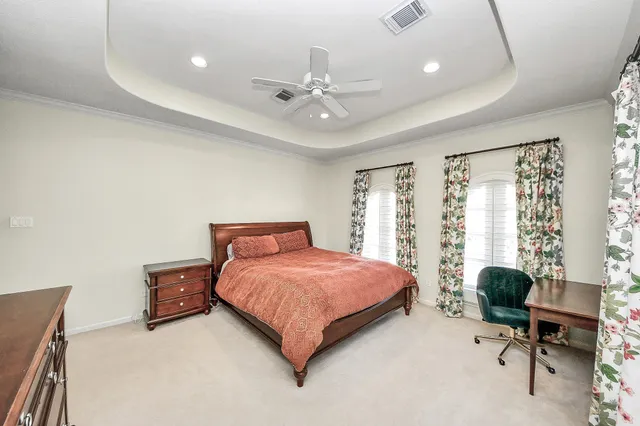 a front view of a house with garden and tree