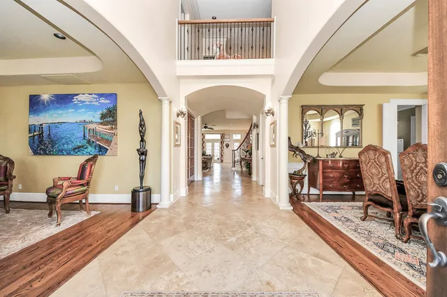 a view of a dining room with furniture and a chandelier