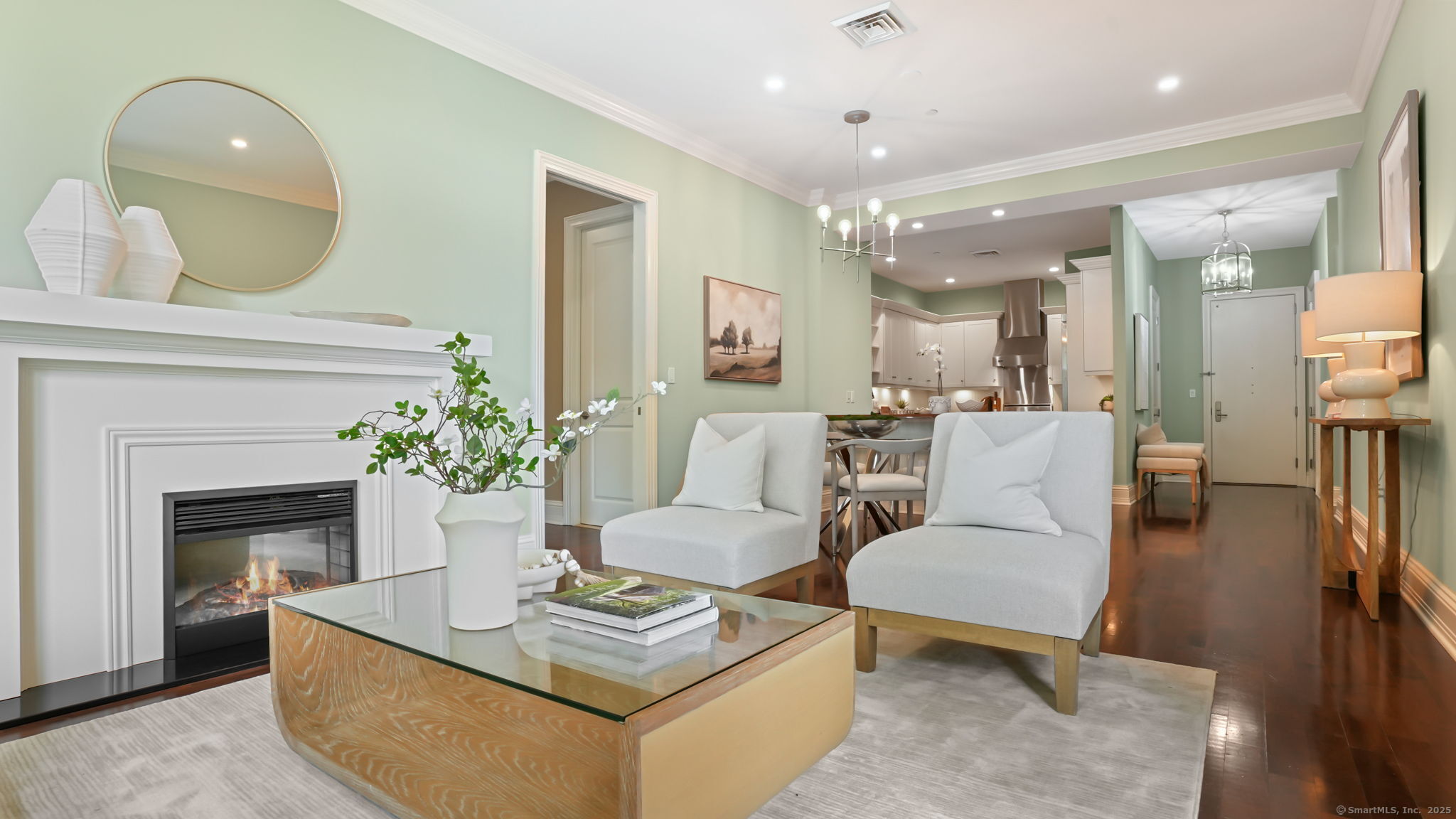 a living room with furniture a fireplace and a potted plant