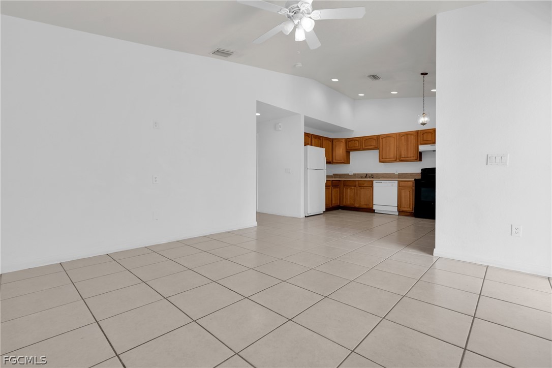 4716-4718 21st Street Southwest Lehigh Acres, FL 33973 - Photo 13 of 21 a room with a white furniture and chandelier
