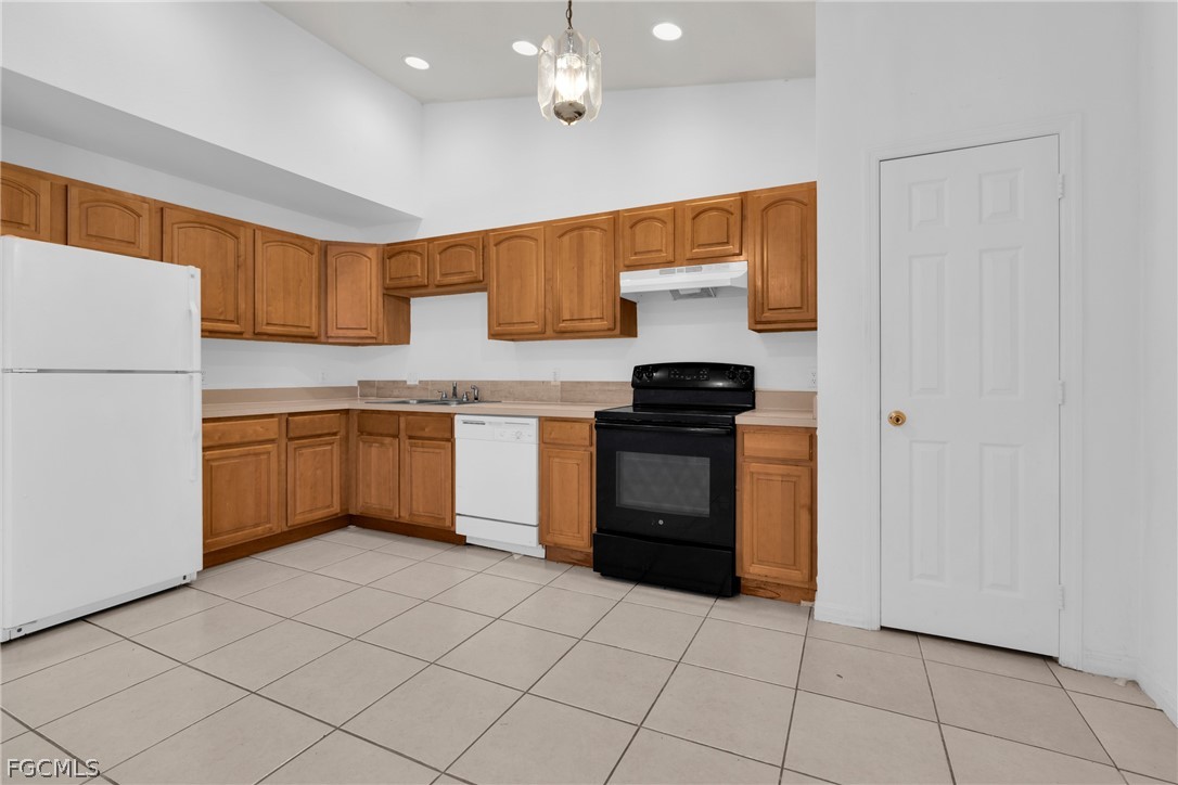 4716-4718 21st Street Southwest Lehigh Acres, FL 33973 - Photo 14 of 21 a kitchen with a stove top oven and cabinets