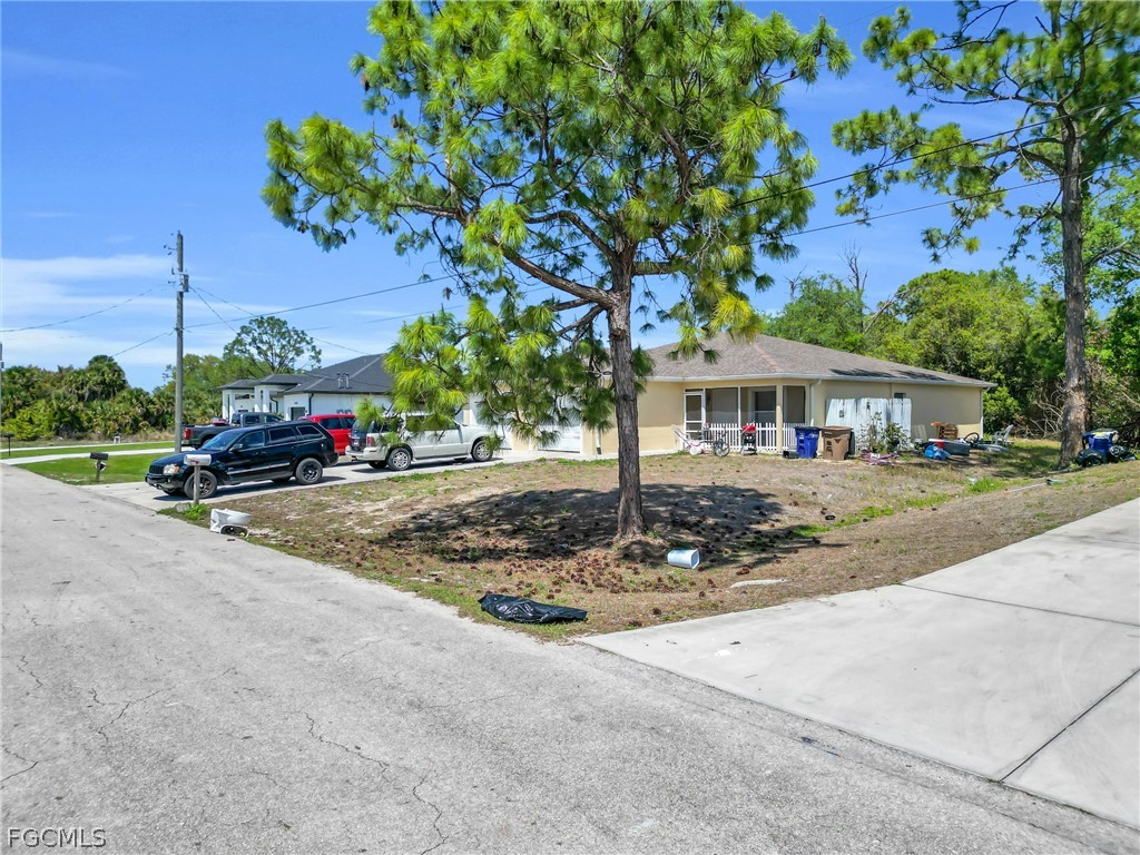 4716-4718 21st Street Southwest Lehigh Acres, FL 33973 - Photo 17 of 21 a front view of a house with a yard