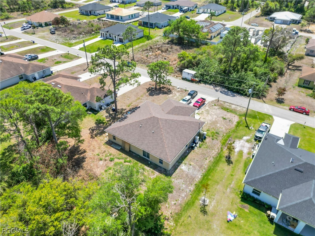4716-4718 21st Street Southwest Lehigh Acres, FL 33973 - Photo 19 of 21 an aerial view of house with yard swimming pool and outdoor seating