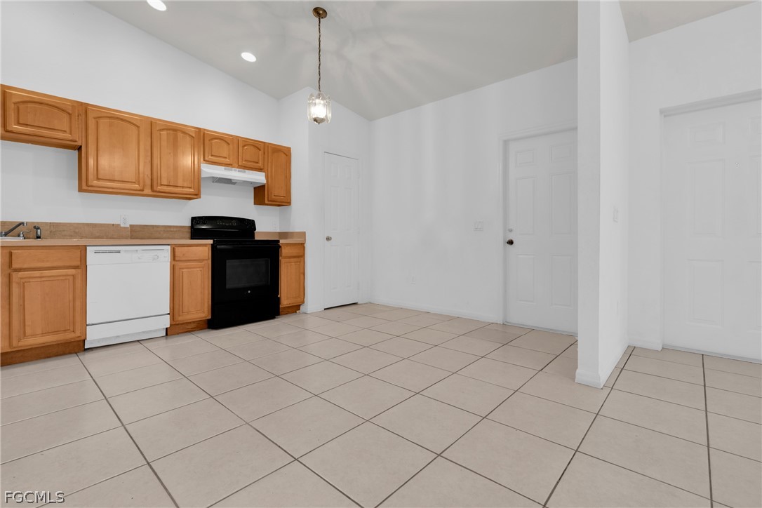 4716-4718 21st Street Southwest Lehigh Acres, FL 33973 - Photo 3 of 21 a kitchen with stainless steel appliances granite countertop a stove a sink and a refrigerator