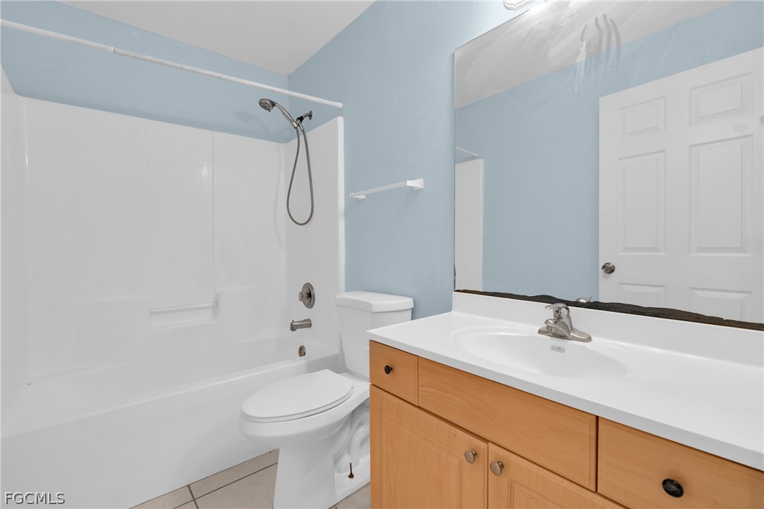 4716-4718 21st Street Southwest Lehigh Acres, FL 33973 - Photo 6 of 21 a bathroom with a sink a toilet and shower