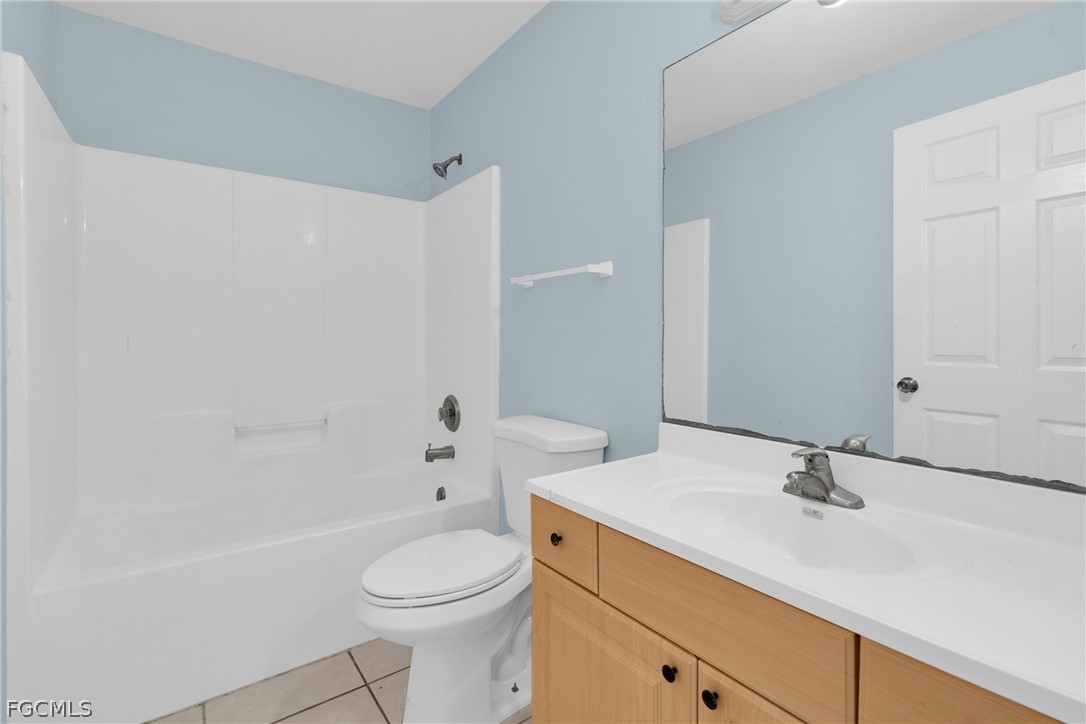 4716-4718 21st Street Southwest Lehigh Acres, FL 33973 - Photo 9 of 21 a bathroom with a sink a toilet and shower