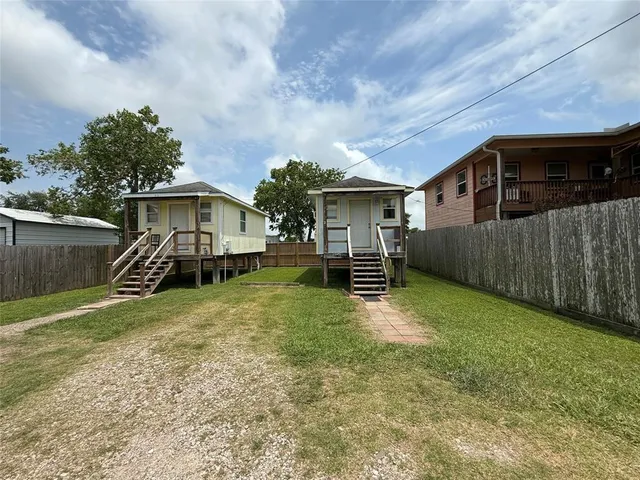 a view of a house with a yard and sitting area