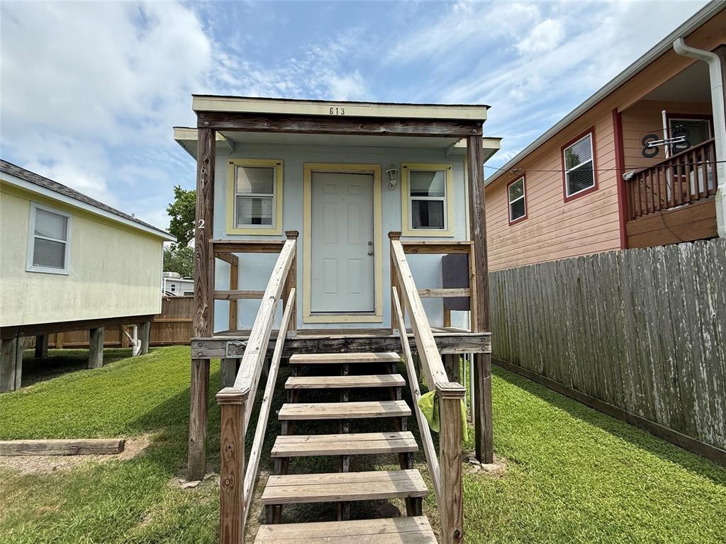 613 24th Street, Unit A Dickinson, TX 77539 - Photo 5 of 15 a view of a house with backyard and wooden fence