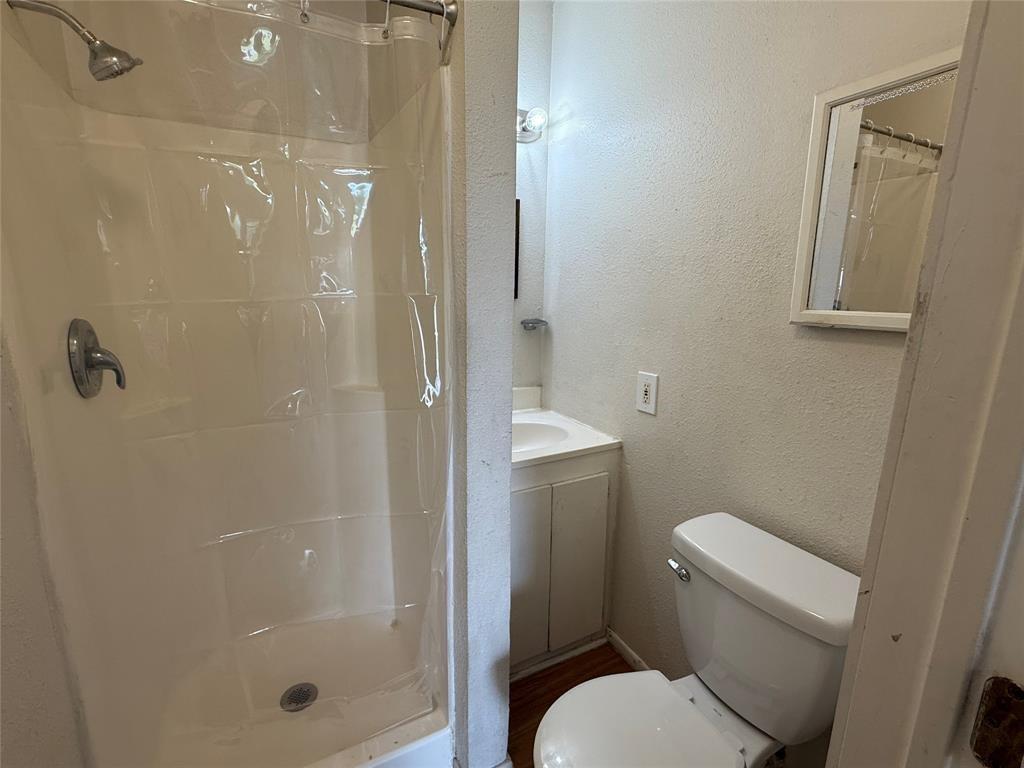 613 24th Street, Unit A Dickinson, TX 77539 - Photo 7 of 15 a bathroom with a shower and a toilet