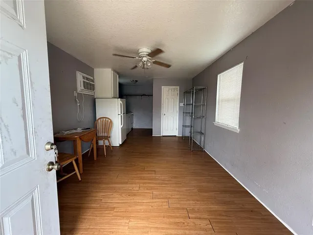 a view of a livingroom with furniture and hardwood floor