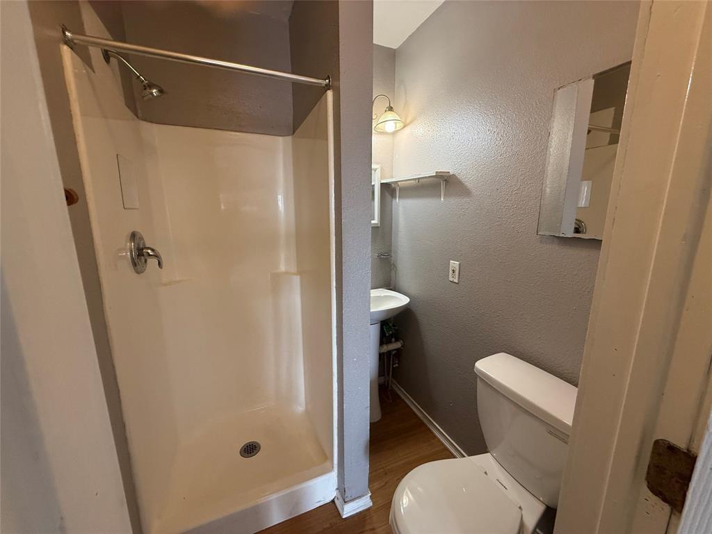 613 24th Street, Unit A Dickinson, TX 77539 - Photo 10 of 15 a bathroom with a shower and toilet