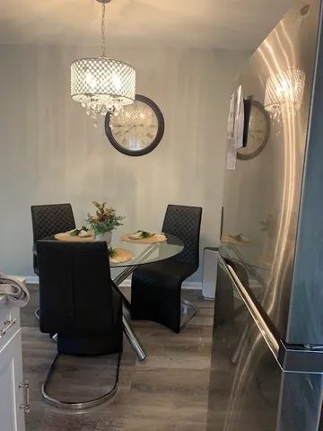 a kitchen with stainless steel appliances granite countertop a refrigerator and a stove top oven