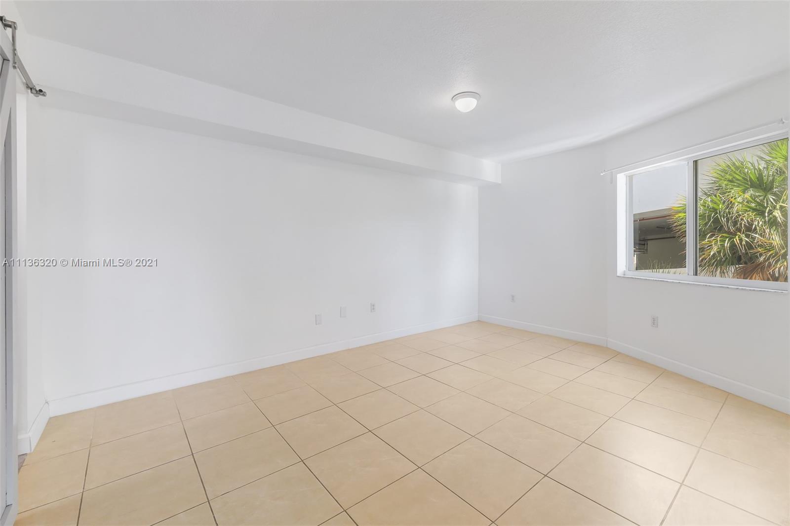 280 Southwest 20th Road, Unit 404 Miami, FL 33129 - Photo 13 of 52 a view of an empty room and window