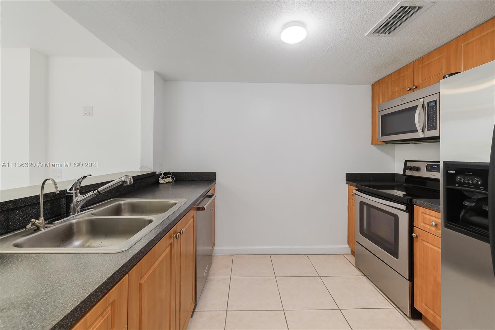 280 Southwest 20th Road, Unit 404 Miami, FL 33129 - Photo 15 of 52 a kitchen that has a sink and a stove