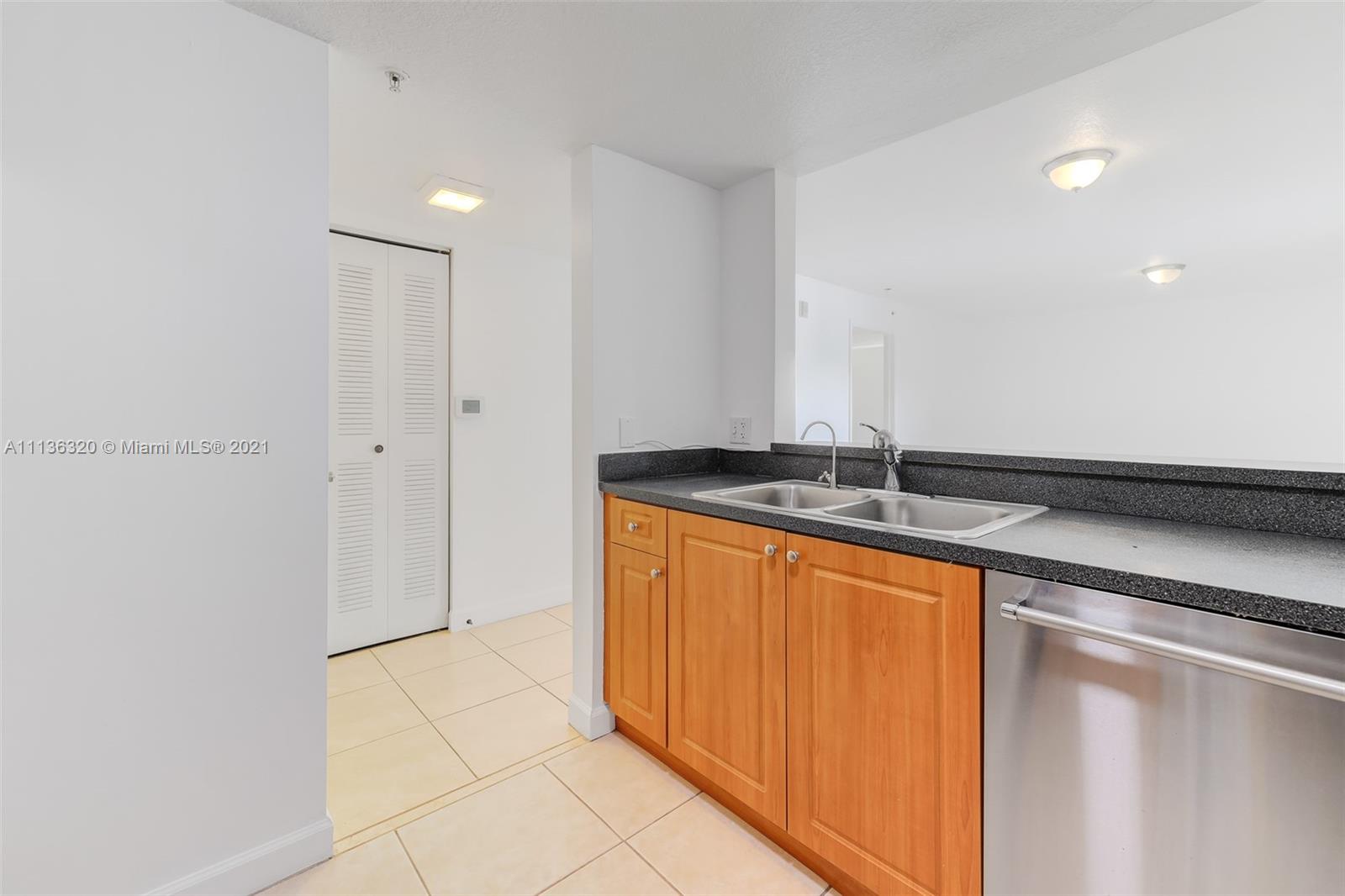 280 Southwest 20th Road, Unit 404 Miami, FL 33129 - Photo 17 of 52 a bathroom with a granite countertop sink and a mirror