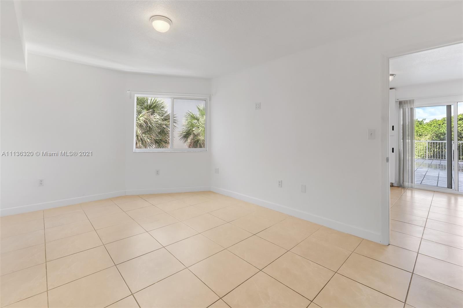 280 Southwest 20th Road, Unit 404 Miami, FL 33129 - Photo 23 of 52 an empty room with windows