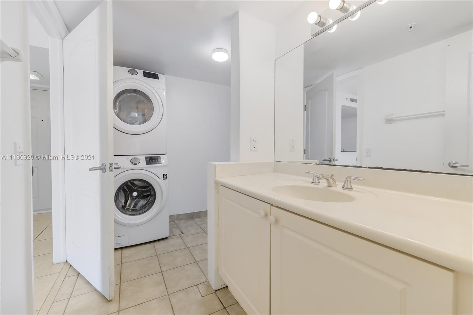 280 Southwest 20th Road, Unit 404 Miami, FL 33129 - Photo 24 of 52 a bathroom with a sink and a washer dryer