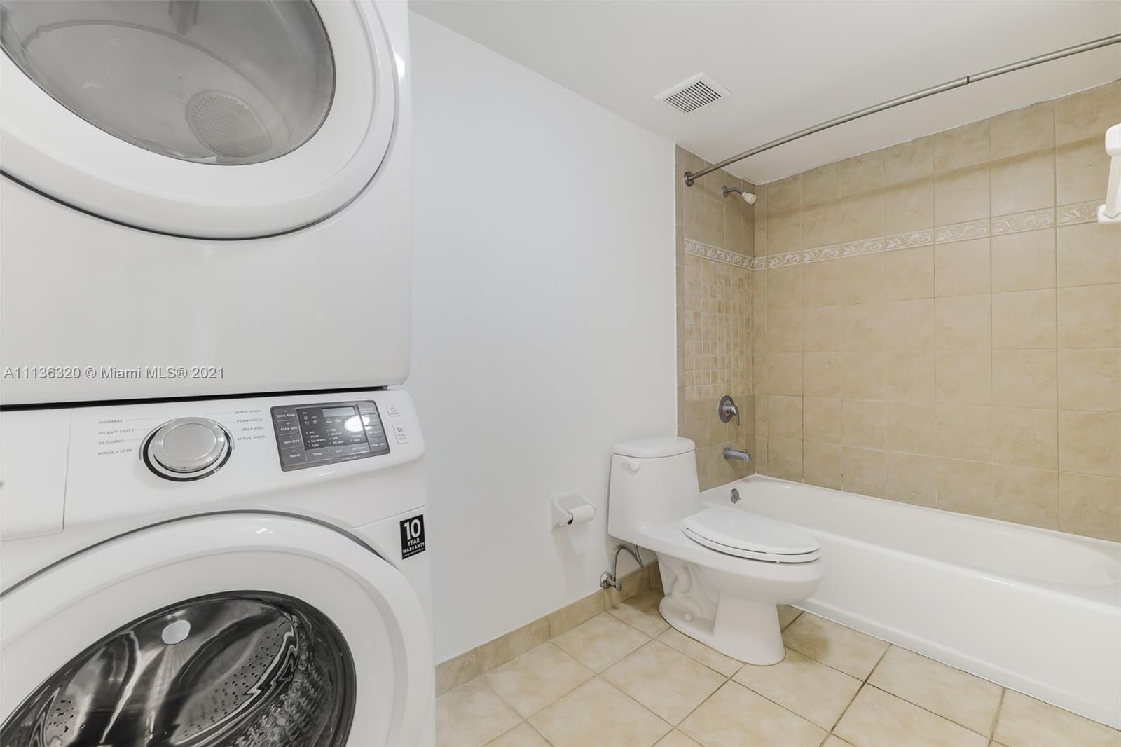 280 Southwest 20th Road, Unit 404 Miami, FL 33129 - Photo 25 of 52 a bathroom with a toilet and a washing machine