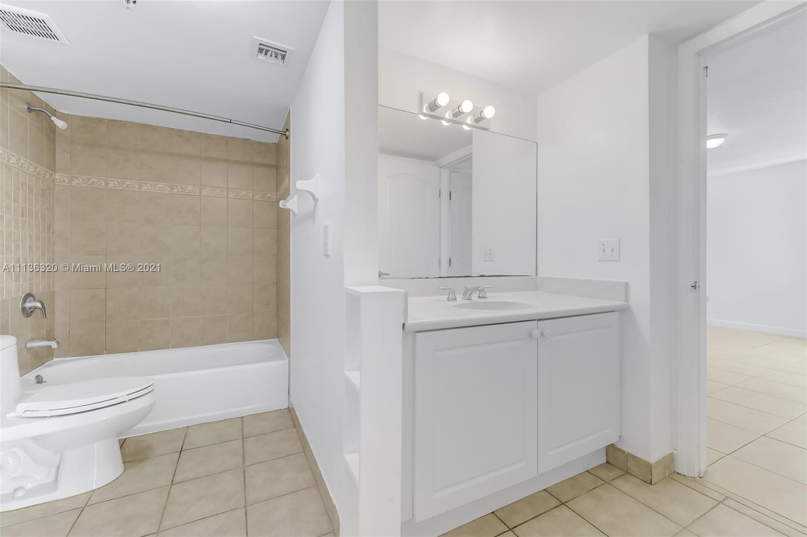 280 Southwest 20th Road, Unit 404 Miami, FL 33129 - Photo 26 of 52 a bathroom with a sink a toilet and shower