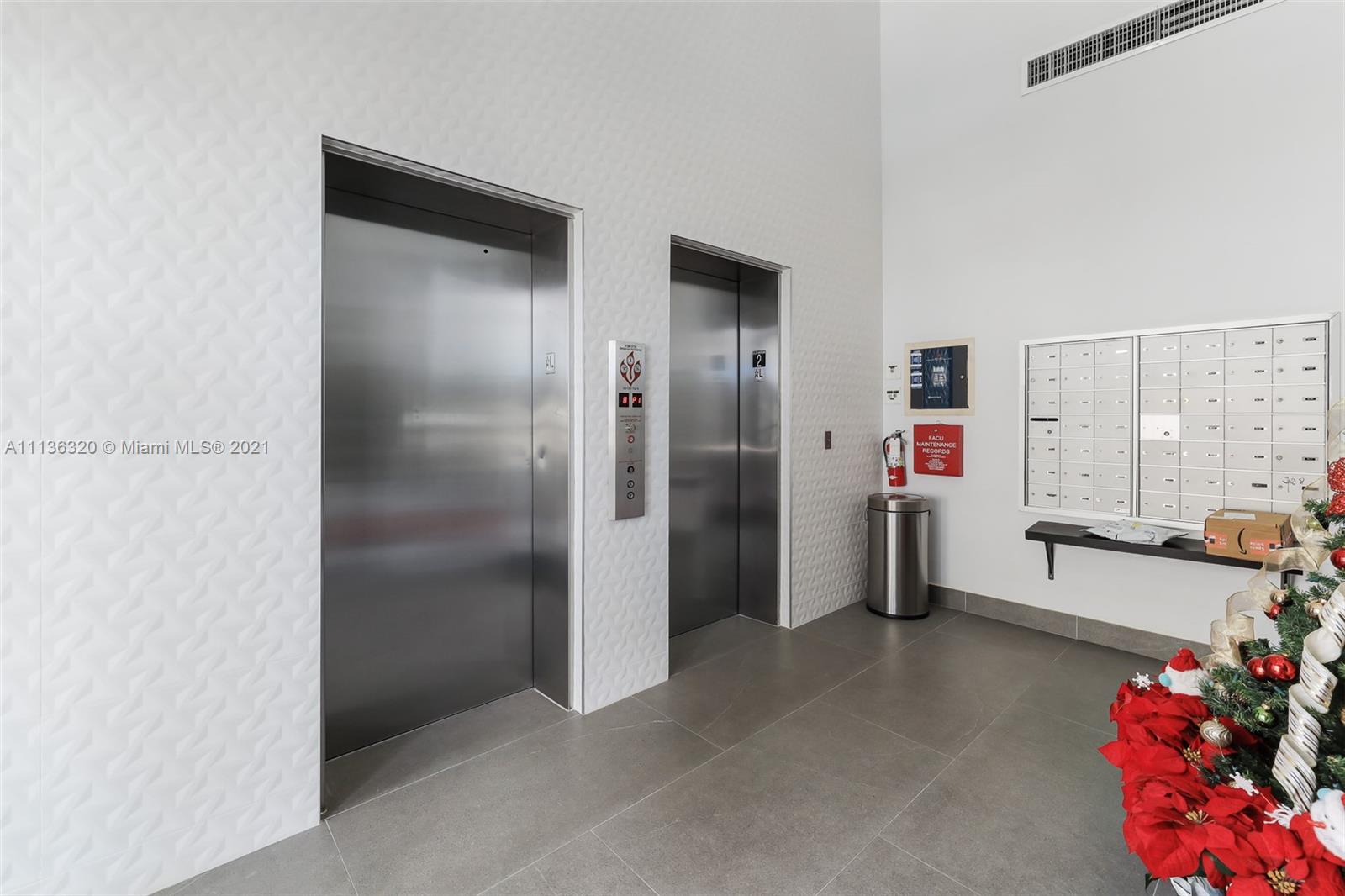 280 Southwest 20th Road, Unit 404 Miami, FL 33129 - Photo 31 of 52 a view of hallway with seating area and chandelier