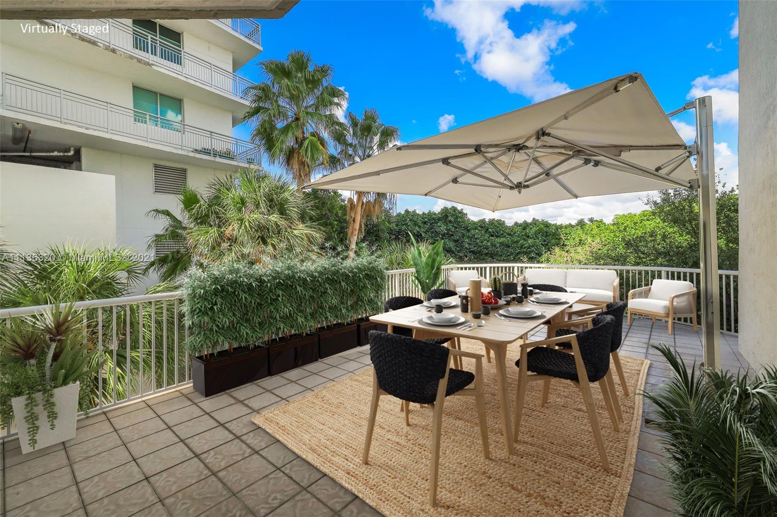 280 Southwest 20th Road, Unit 404 Miami, FL 33129 - Photo 32 of 52 a view of a patio with a table and chairs
