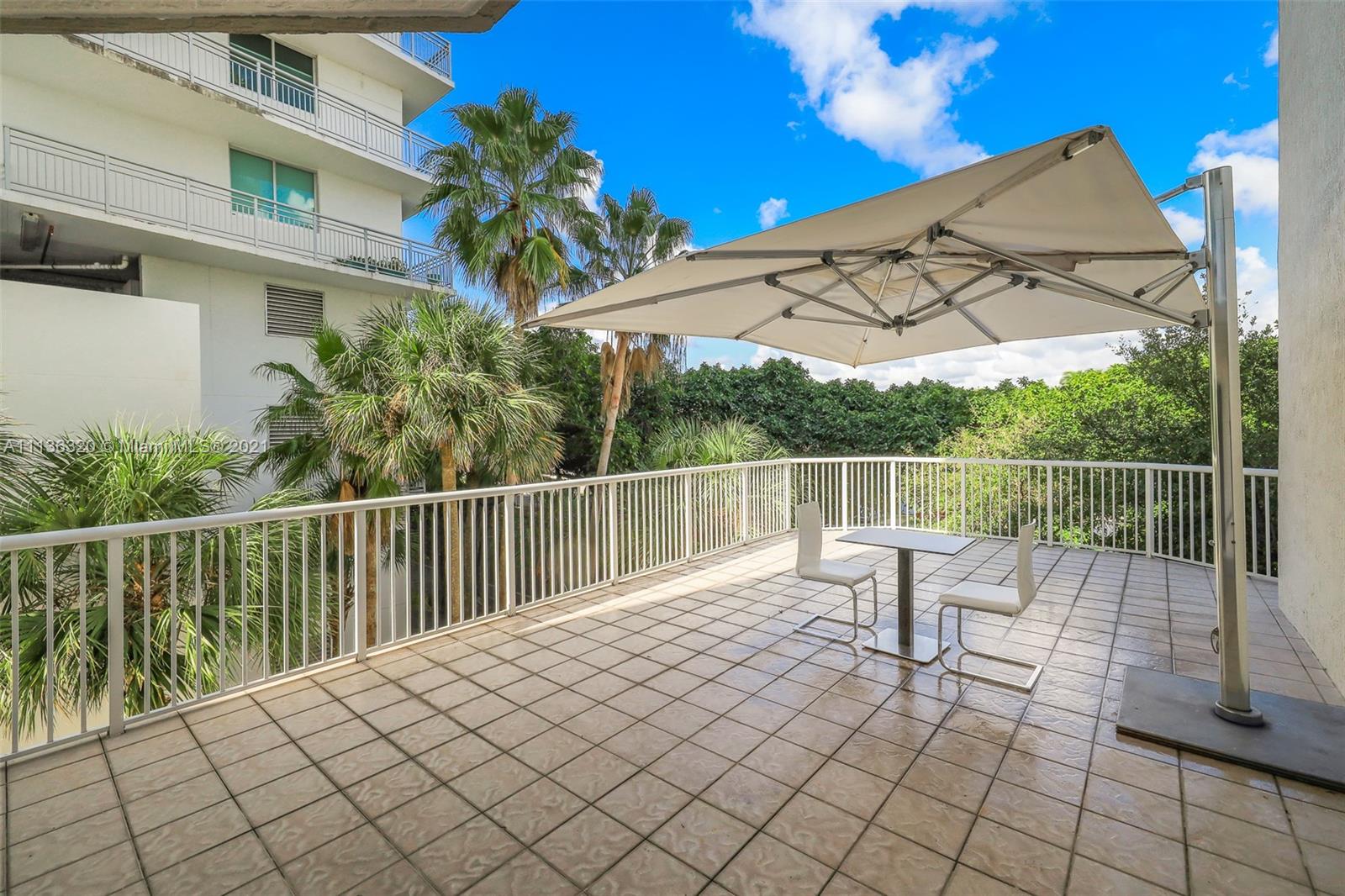 280 Southwest 20th Road, Unit 404 Miami, FL 33129 - Photo 37 of 52 a view of a chair and tables on the terrace