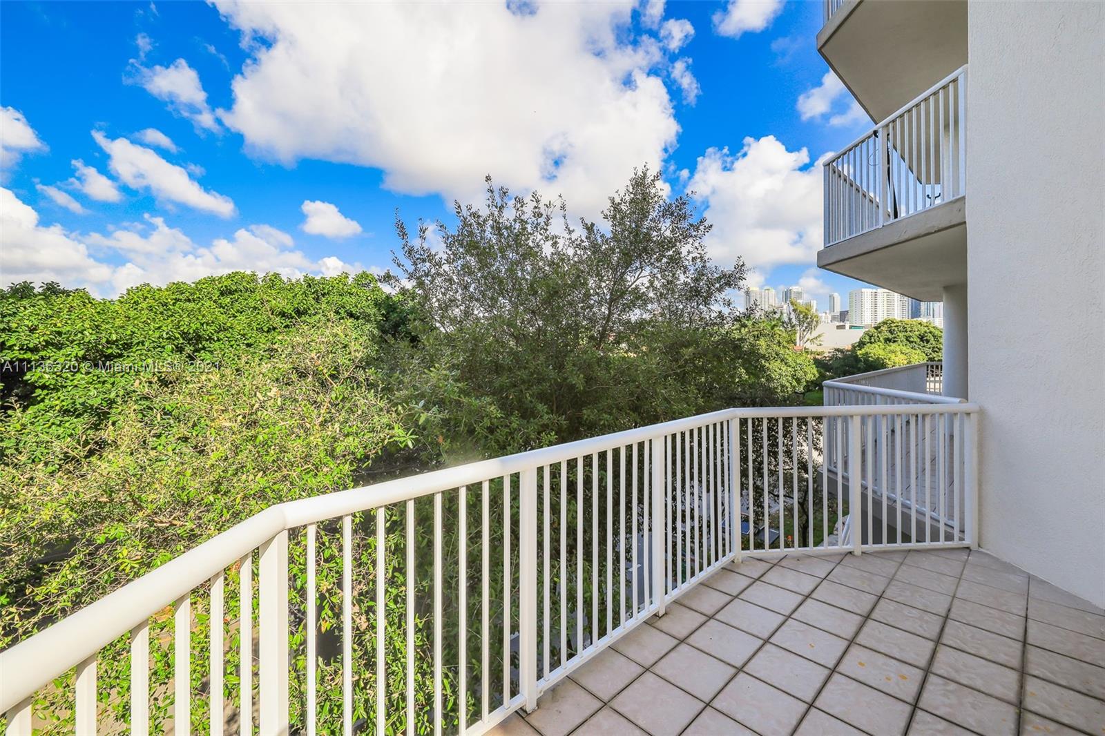 280 Southwest 20th Road, Unit 404 Miami, FL 33129 - Photo 39 of 52 a balcony with trees in the back yard