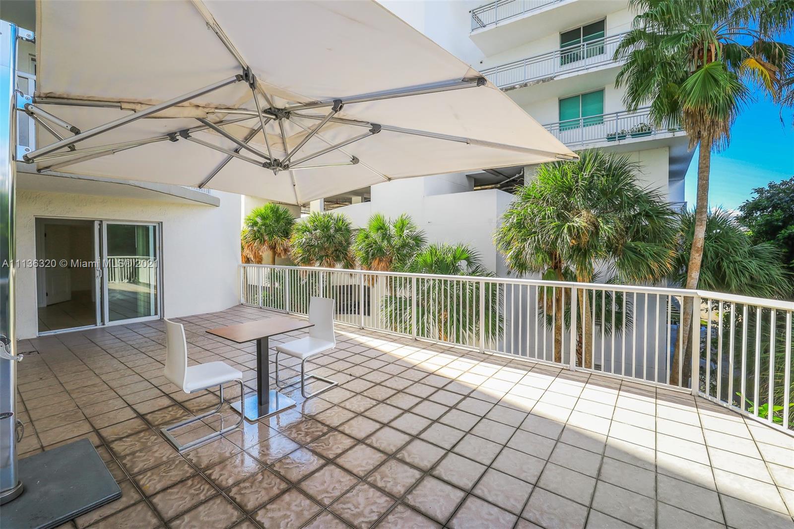 280 Southwest 20th Road, Unit 404 Miami, FL 33129 - Photo 40 of 52 a balcony with wooden floor