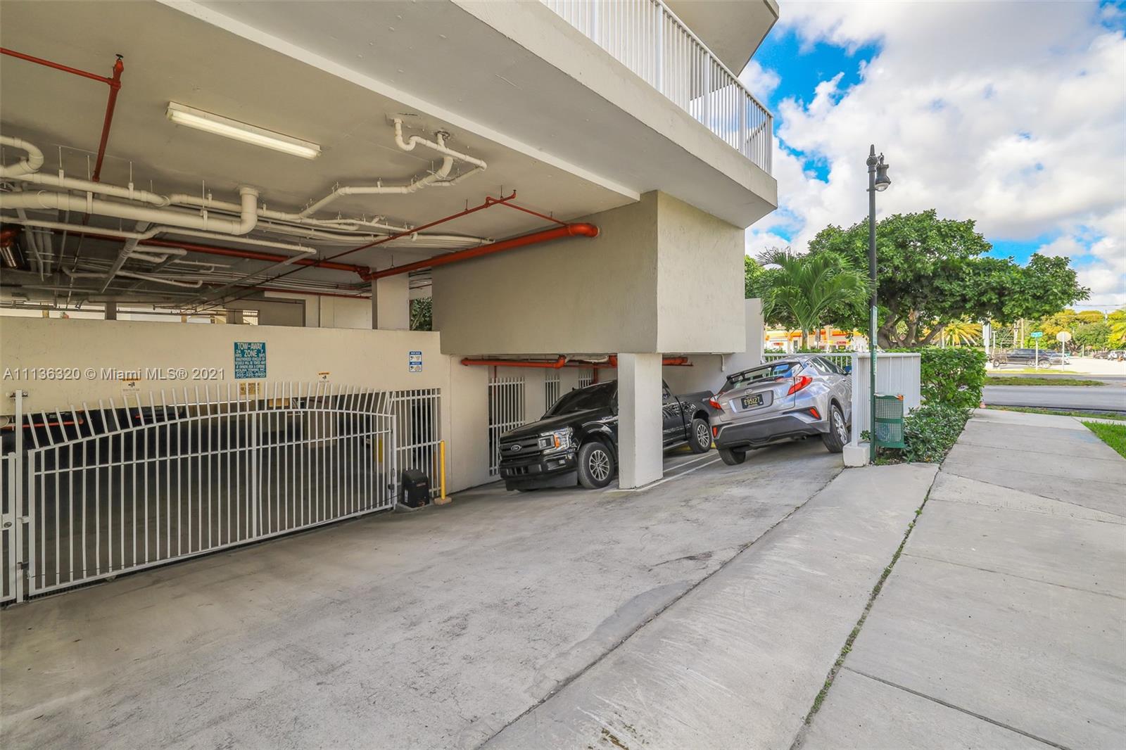 280 Southwest 20th Road, Unit 404 Miami, FL 33129 - Photo 41 of 52 a view of a garage with parked cars