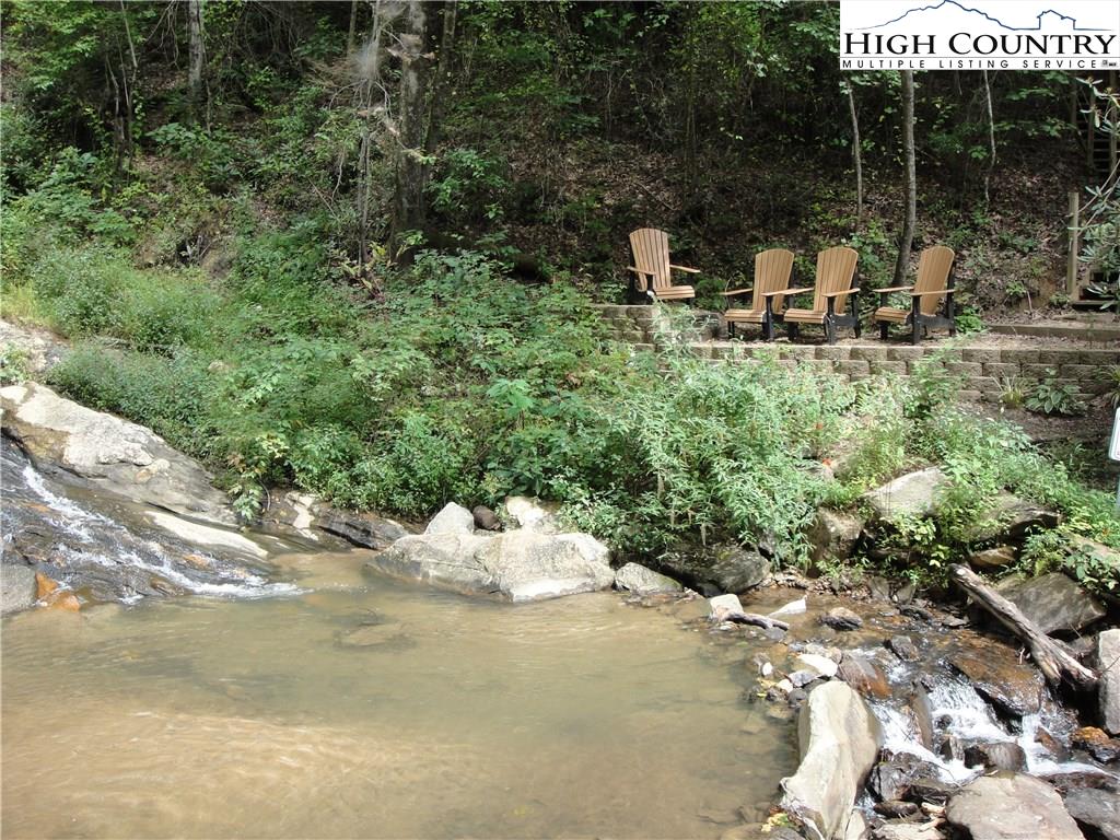72-73 Buck Mountain Road Purlear, NC 28665 - Photo 38 of 47 a view of a chair and tables in the patio