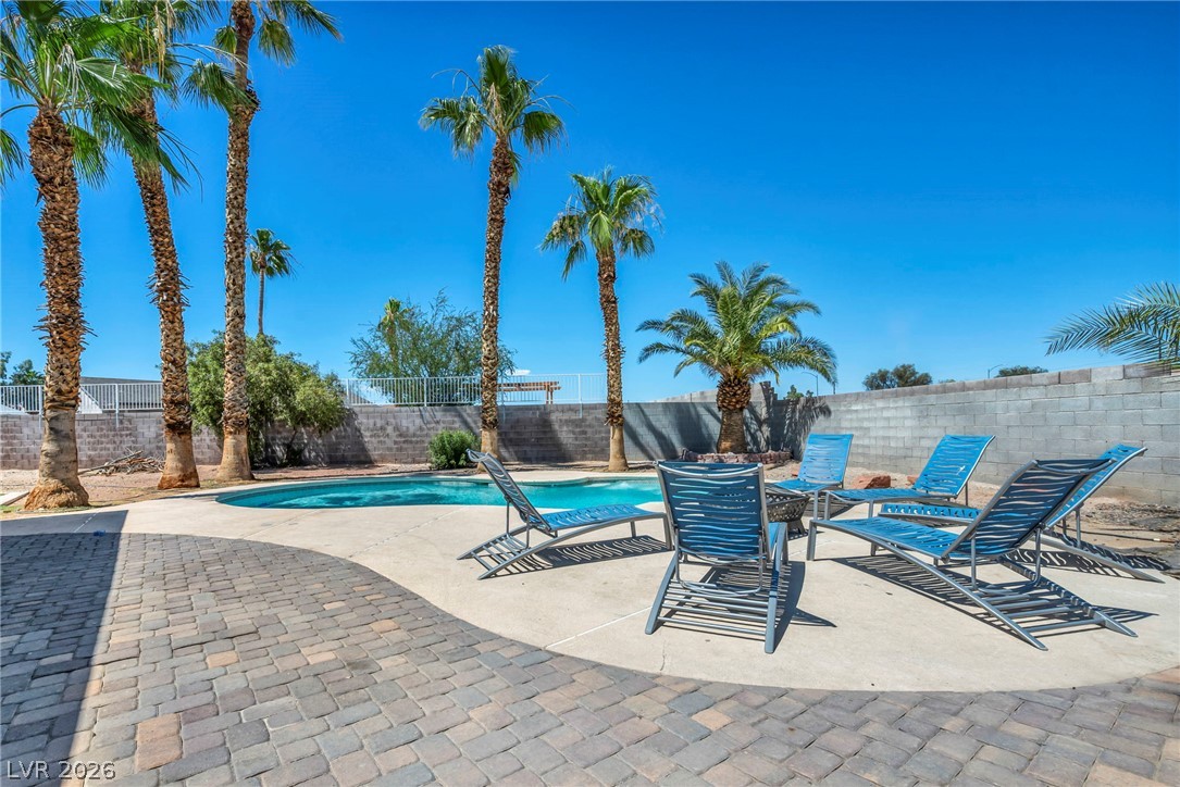 5882 Rio Tinto Way Las Vegas, NV 89110 - Photo 56 of 56 A private outdoor oasis, featuring a glistening pool and mature palm trees for ultimate relaxation.