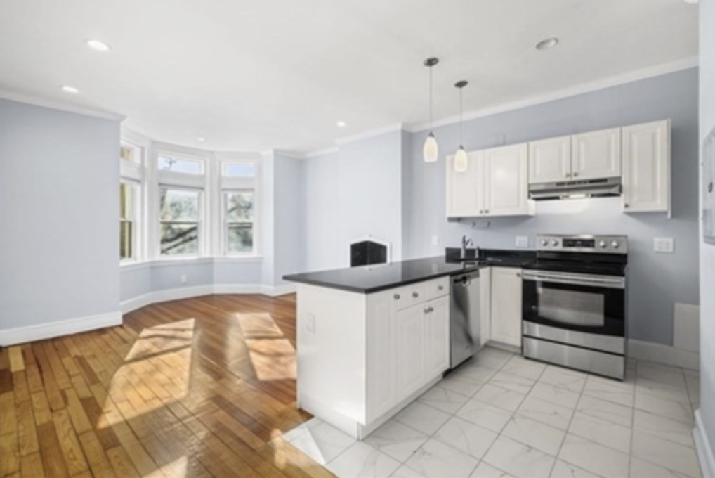 1834 Beacon Street, Unit 5 Brookline, MA 02445 - Photo 1 of 6 a kitchen with a stove a sink and a refrigerator