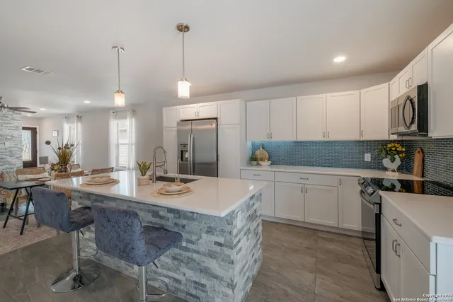 a kitchen with a sink stove and cabinets