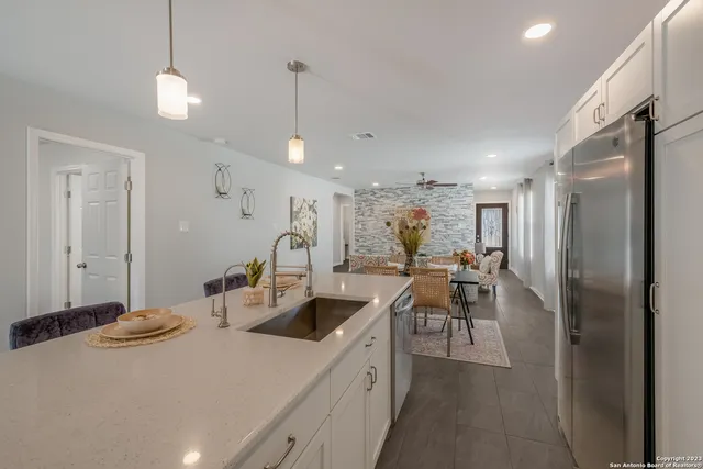 a kitchen with sink cabinets and living room view